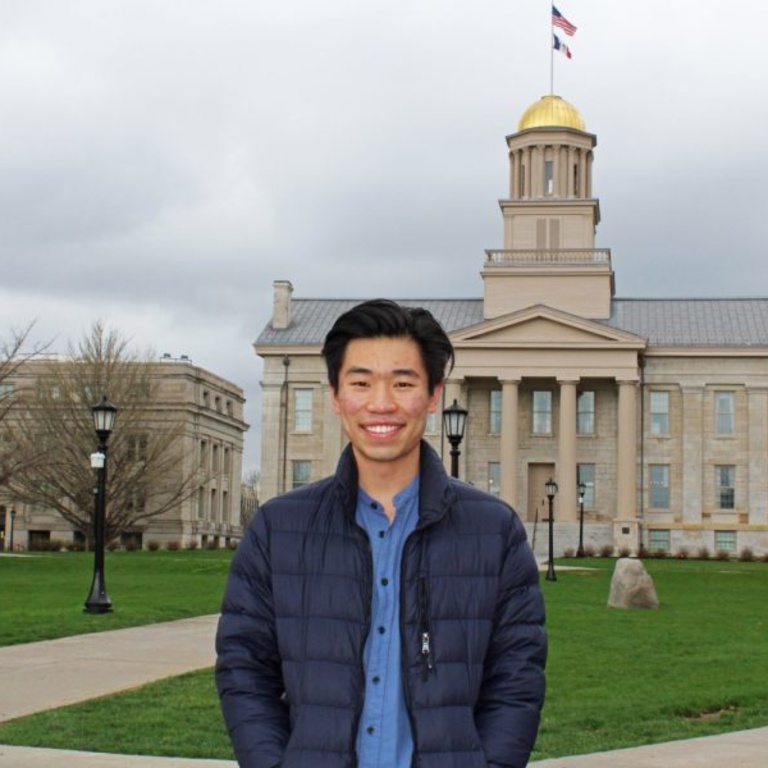 Guowei Qi stands in front of the Old Capitol